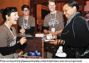 Chobani workers giving sample to smiling woman